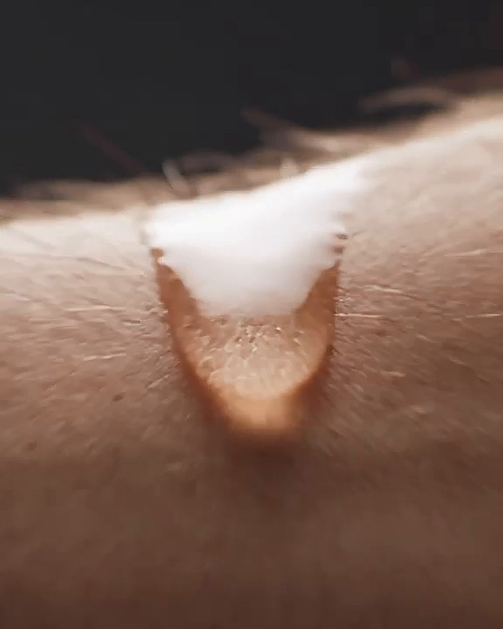 A drop of gel texture on skin, macro shot