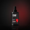 Signature Vitalizer Multi-V Face Serum, black dropper bottle on a dark reflective surface with red accent light
